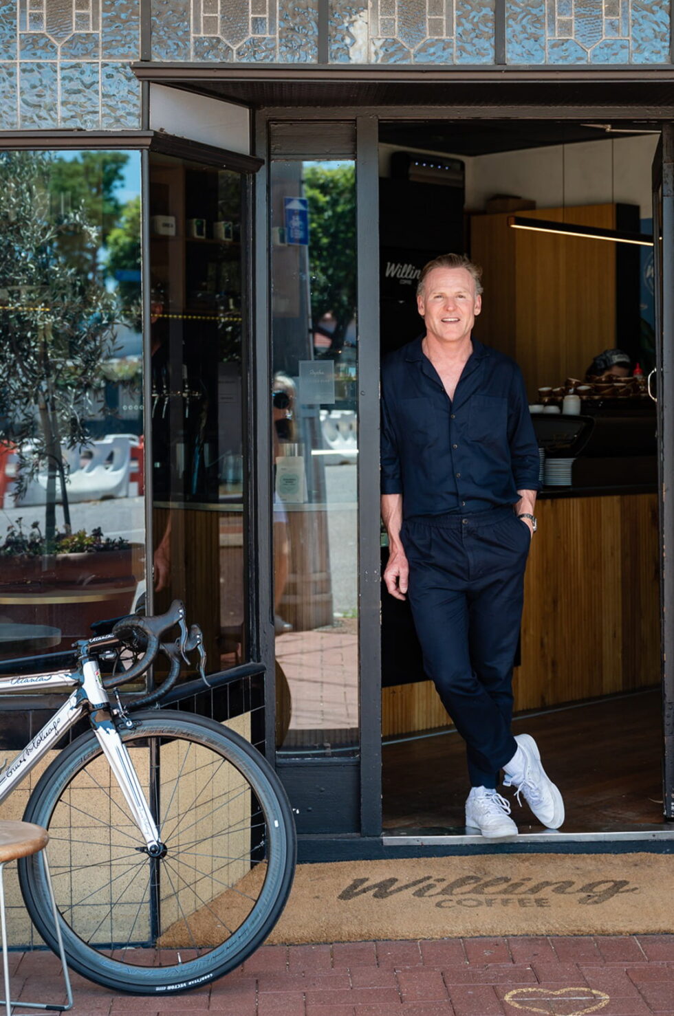 Tim Willing of WIlling Property standing in a door way of Willing coffee